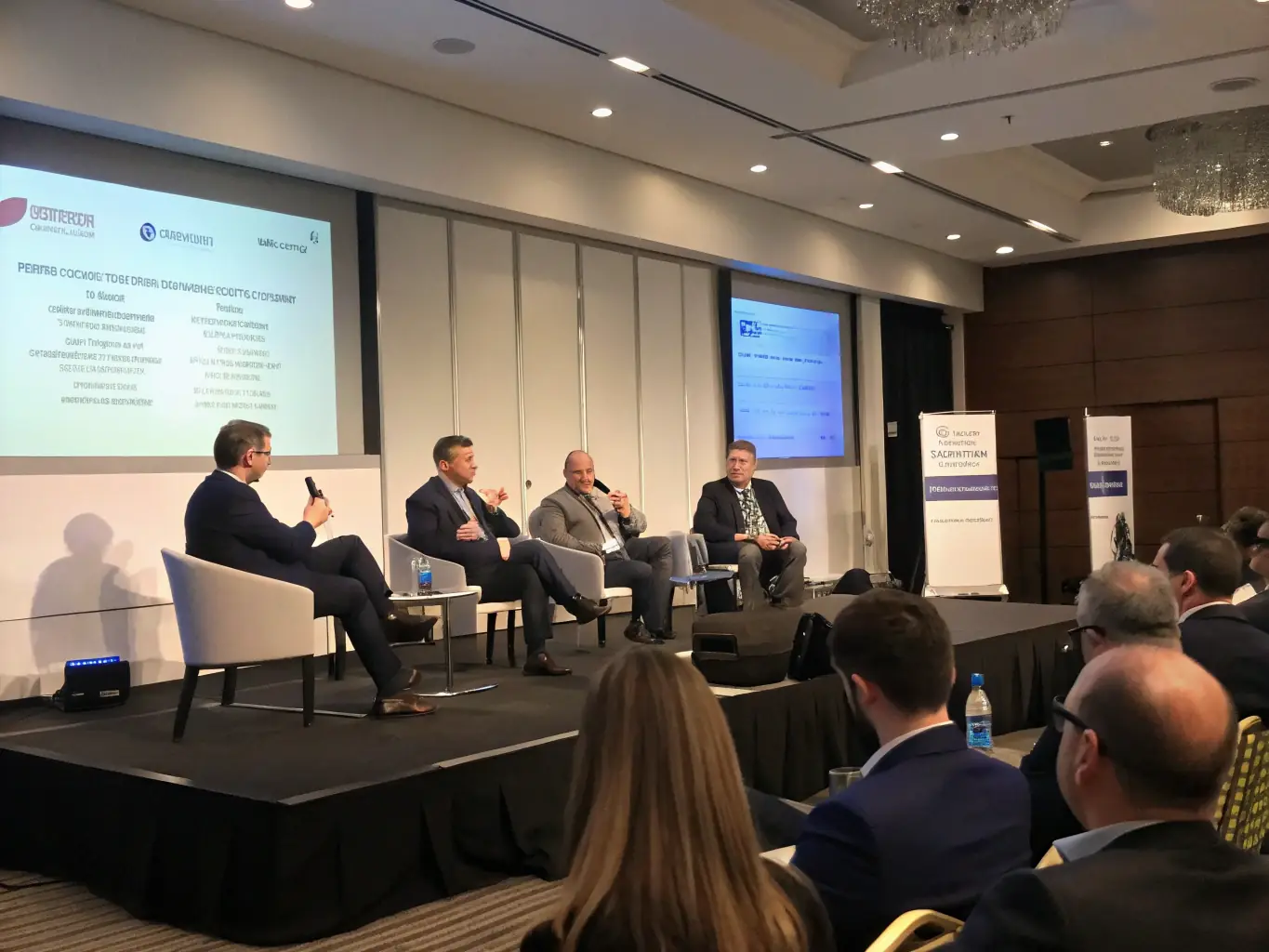 A professional photograph of a panel discussion at a datastreams.site leadership conference, featuring a diverse group of experts sharing their perspectives.
